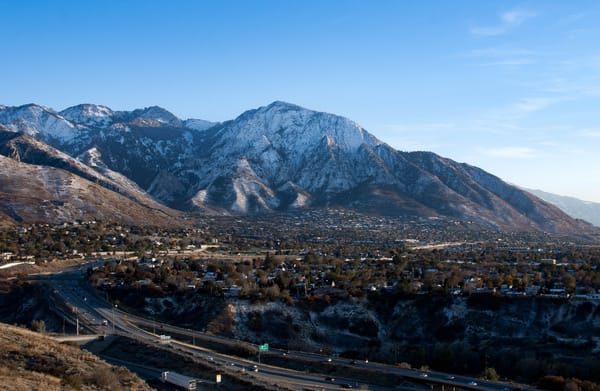 A view of the Wasatch Mountains, taken in early November, showcasing the neighborhoods nestled up against the slopes, and the beginnings of a snowy winter.